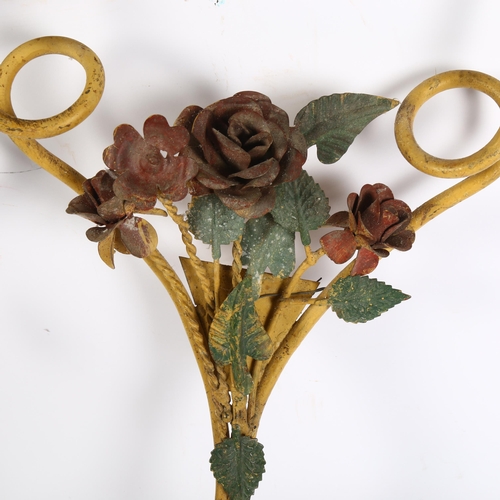 307 - A pair of scrolled painted metal 2-branch wall sconces, with rose decoration, length 50cm