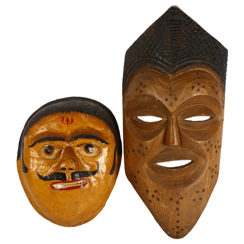 308 - An Oriental design papier mache mask, length 40cm, and a carved hardwood African mask, length 70cm (... 