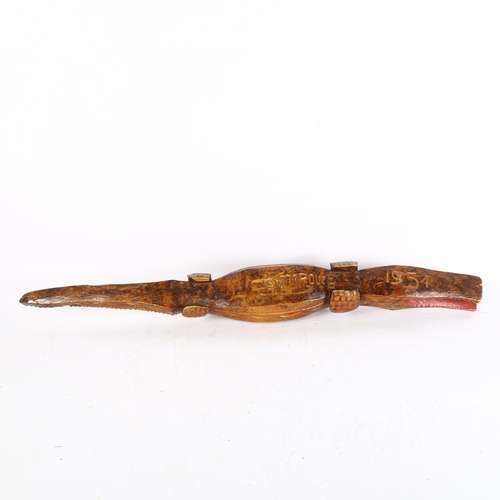 316 - A carved wood crocodile, incised to the underside L Comaroves 1951, length 90cm