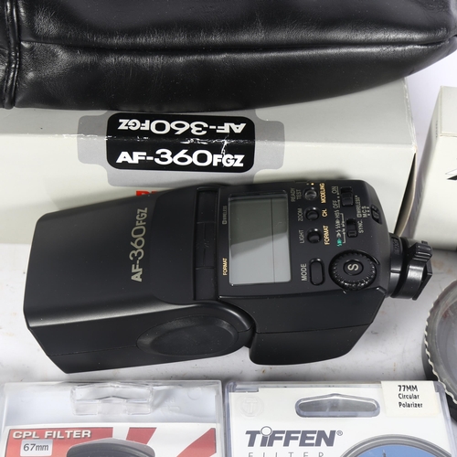 326 - A boxed Pentax flash gun, working, 2 extra small flash guns, an ultraviolet filter, a polarising fil... 