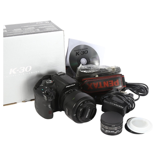 331 - A Pentax K30 camera, including an SMC Pentax DA18-55mm lens, battery charger and filters, boxed, wor... 