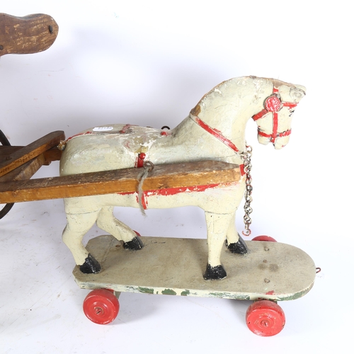 337 - An early 20th century painted wooden horse on wheeled base, 32cm, and an associated cart, cart lengt... 