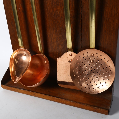 445 - A set of 4 French copper utensils, with associated oak backing board, board height 48cm, width 32cm