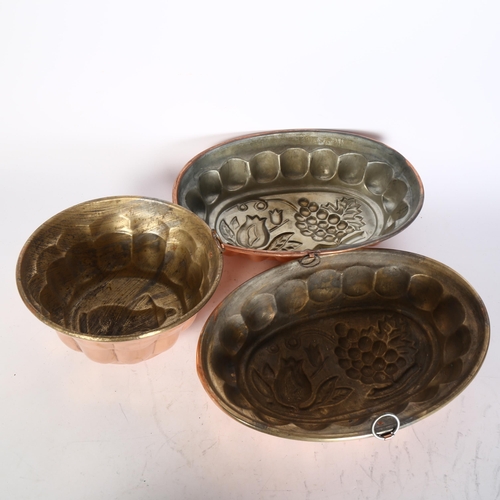 451 - A group of 3 French or Italian copper jelly moulds, the 2 larger moulds have grape and flower decora... 