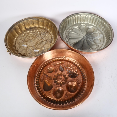 453 - A group of 3 Vintage French copper cake or jelly moulds, the moulds have floral or fruit decoration,... 