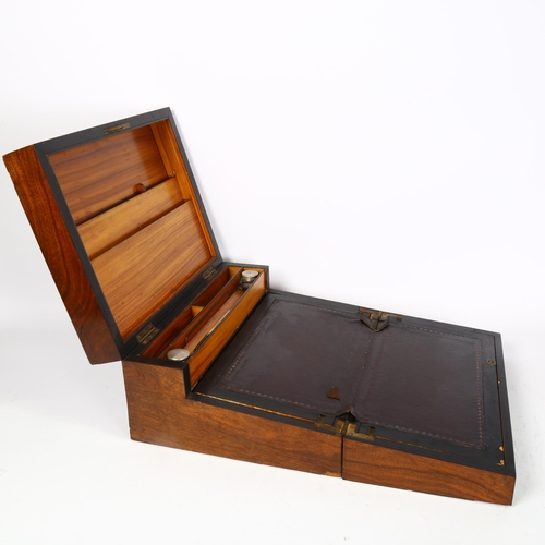 469 - A Victorian walnut fold-out writing desk, writing desk is ebony banded, with bone inlay, there are a... 