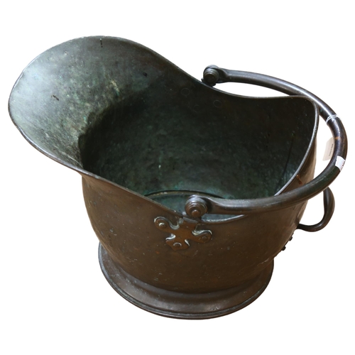 486 - A Victorian brass coal scuttle, with decorative handle brackets, length 46cm