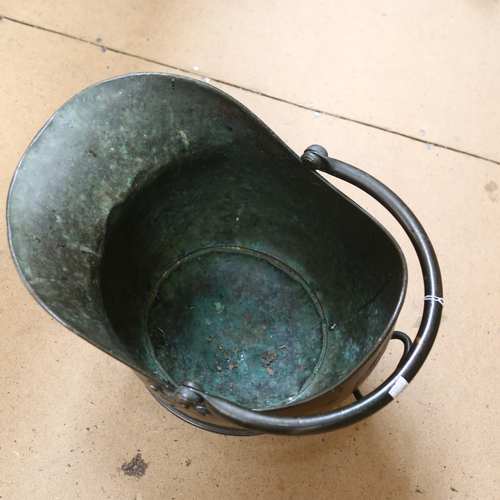 486 - A Victorian brass coal scuttle, with decorative handle brackets, length 46cm