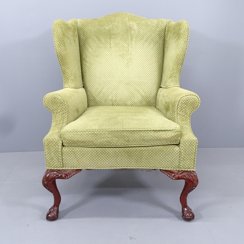 2192 - A mahogany and upholstered Queen Anne style wingback armchair, on cabriole legs with claw and ball f... 