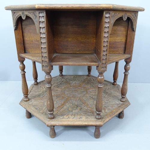 2193 - A Victorian Arts & Crafts octagonal two-tier library table, with relief carved foliate decoration. 7... 