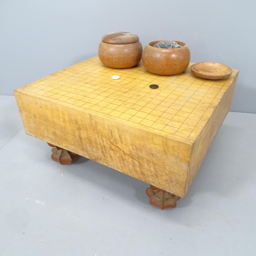 2202 - A modern Japanese solid wood Go board with two pots of black and white counters, 45x25x42cm