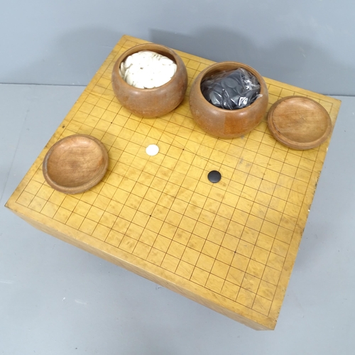 2202 - A modern Japanese solid wood Go board with two pots of black and white counters, 45x25x42cm