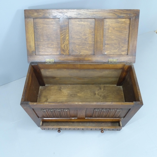 2203 - A modern panelled oak blanket box with carved linenfold decoration. 96x61x45cm.