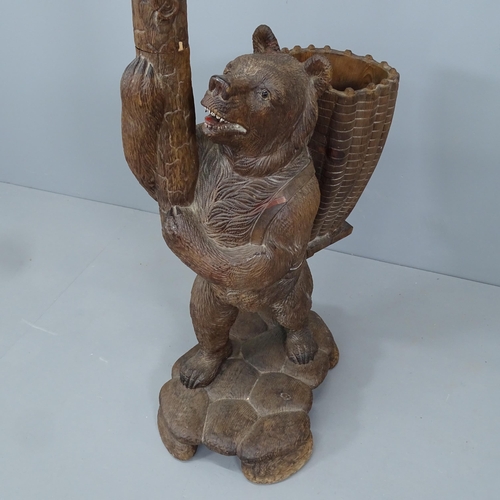 2207 - A large and impressive Black Forest hall stand in the form of a bear holding a branch, with hand pai... 