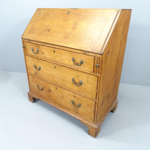 2210 - A 19th century pine bureau, the fall-front revealing a fitted interior with three long drawers below... 