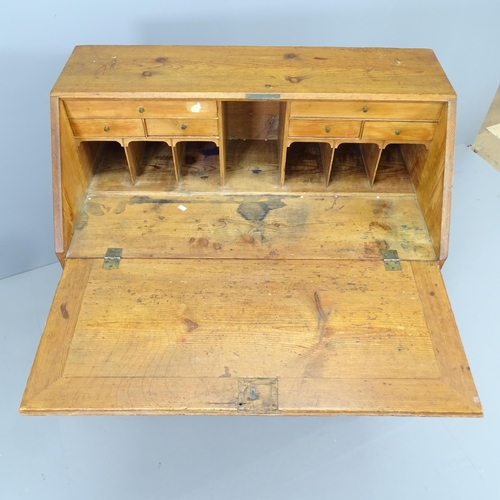 2210 - A 19th century pine bureau, the fall-front revealing a fitted interior with three long drawers below... 