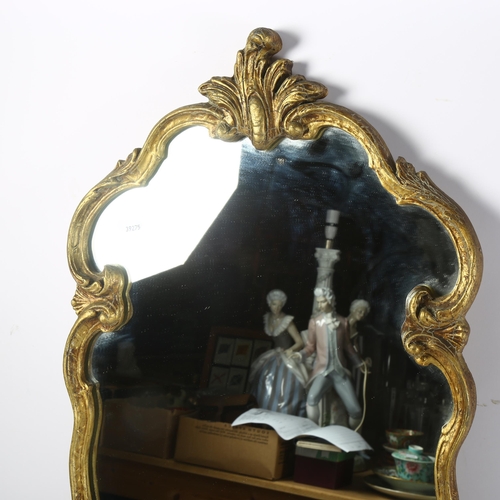 365 - A shield-shape gilt-framed wall mirror, length 78cm