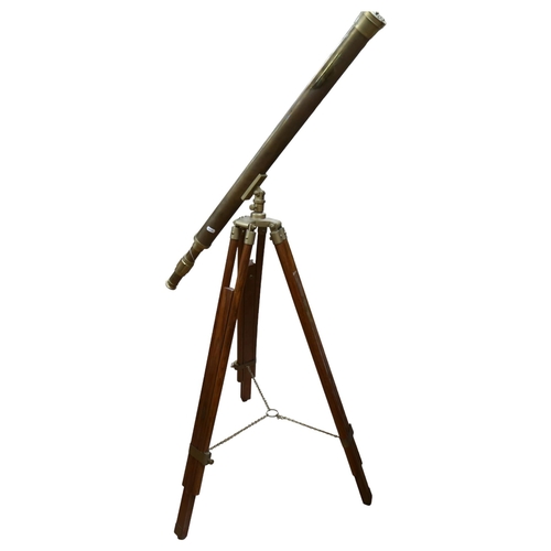 370 - A reproduction brass telescope, on adjustable tripod stand