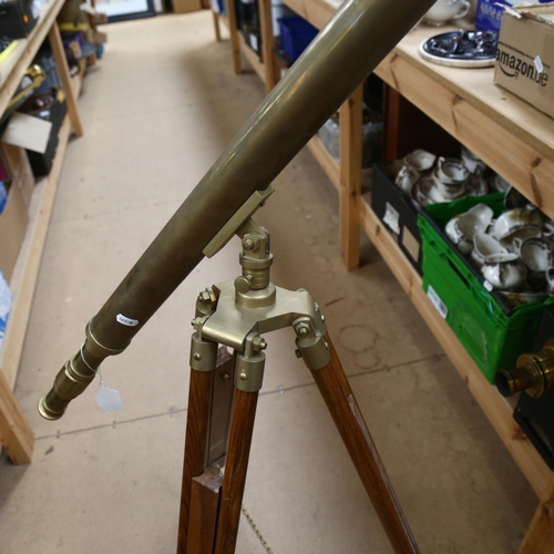 370 - A reproduction brass telescope, on adjustable tripod stand