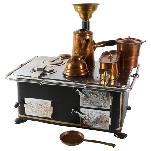 70 - A Vintage tinplate miniature cooking stove, unmarked, with associated accessories, height to top of ... 