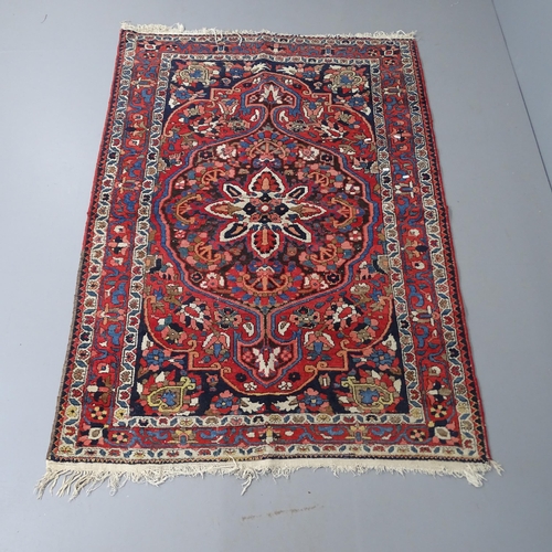 2295 - A red-ground Sarouk rug. 200x136cm