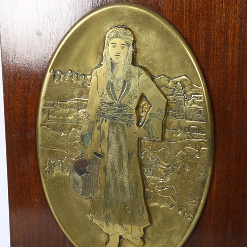 581 - J. Kazazian?, an embossed oval bronze plaque, study of a Middle Eastern water carrier, mounted on te... 