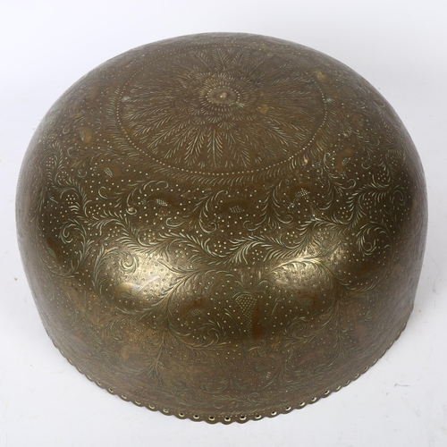 598 - A Tibetan engraved brass singing bowl with design of figures and foliage, and shaped pierced rim, 30... 