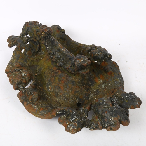 600 - A Victorian cast-iron boot scraper, with animal mask and face decoration, length 43cm