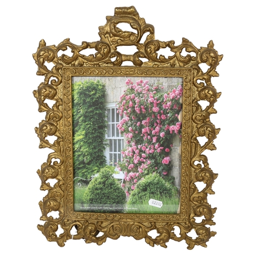 612 - A cast gilt-metal photo frame with scrolled and pierced foliate design, height 42.5cm