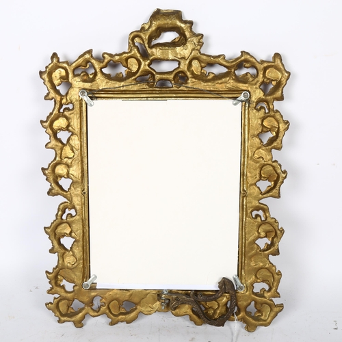 612 - A cast gilt-metal photo frame with scrolled and pierced foliate design, height 42.5cm