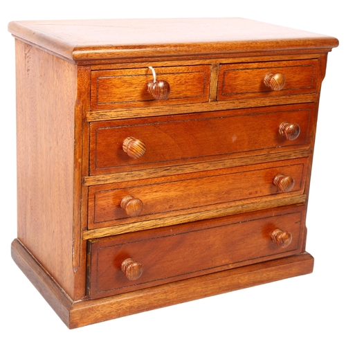 614 - A stained wood table-top chest of 2 short and 3 long drawers, height 25.5cm