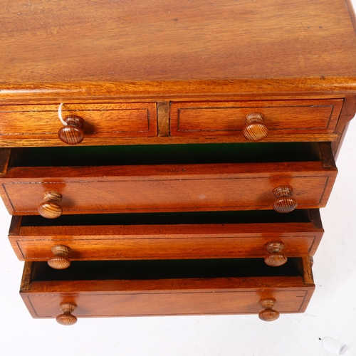 614 - A stained wood table-top chest of 2 short and 3 long drawers, height 25.5cm