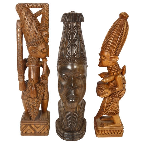 626 - An African carved Benin head hardwood lamp base, height 40cm, and a pair of carved wood figures, sig... 