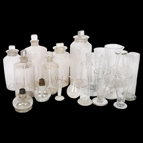 640 - A group of Chemist's bottles and stoppers, and 8 measuring glasses etc