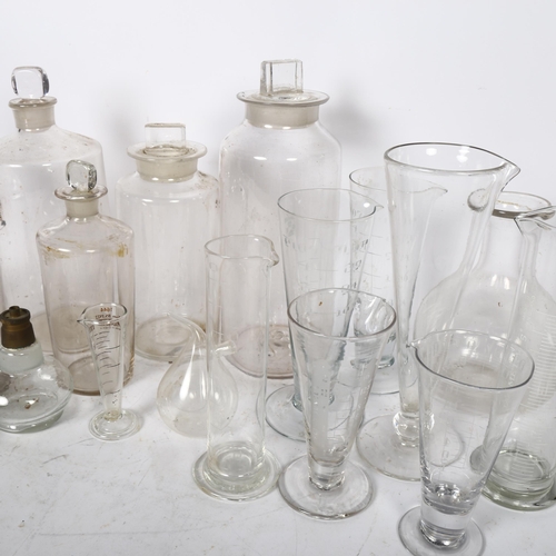 640 - A group of Chemist's bottles and stoppers, and 8 measuring glasses etc