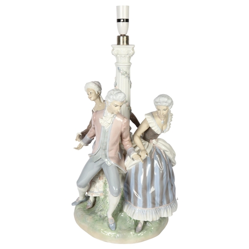 642 - A large Lladro porcelain table lamp supported by 3 figures in Period costume, on plinth (A/F), heigh... 