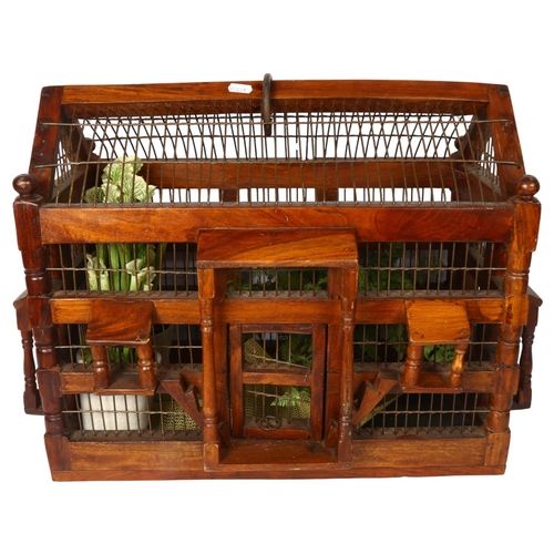 646 - A polished wood and wirework bird cage, length 58cm overall, height 41cm