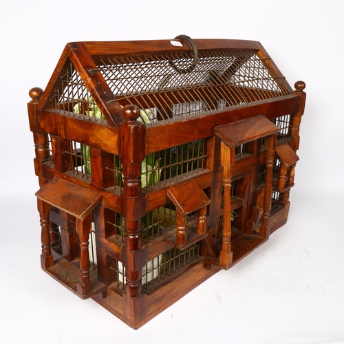 646 - A polished wood and wirework bird cage, length 58cm overall, height 41cm