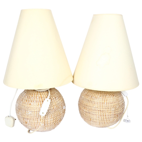 650 - A pair of woven raffia table lamps, with cream shades, height 49cm