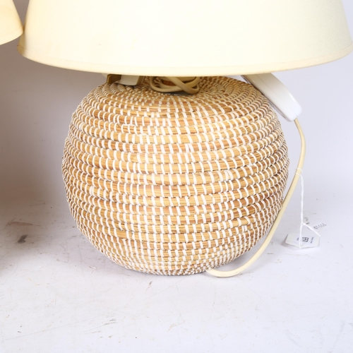 650 - A pair of woven raffia table lamps, with cream shades, height 49cm