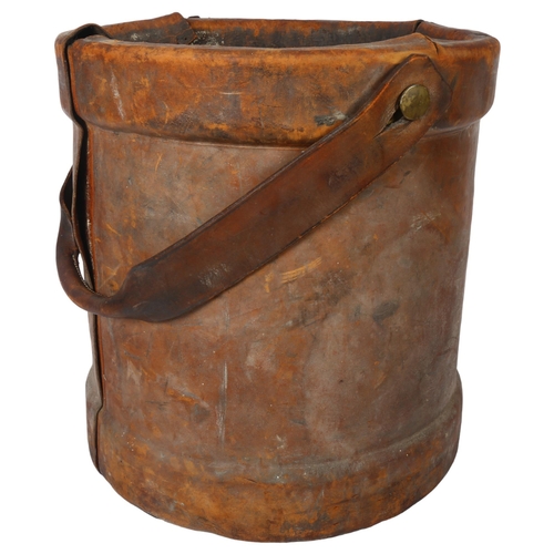 656 - An early 20th century canvas-lined leather-covered powder bucket, with swing handle, height 37cm