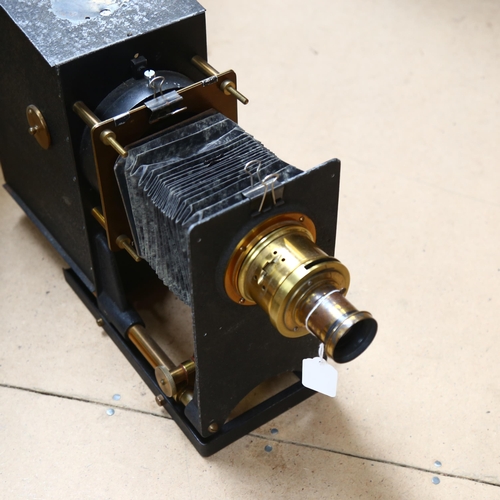 673 - A Victorian painted and brass-mounted magic lantern, with bellow slide, H34cm, base L30cm