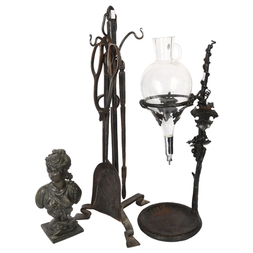 699 - A wrought-iron fire companion set on stand, a patinated spelter bust, and a wine jug on stand