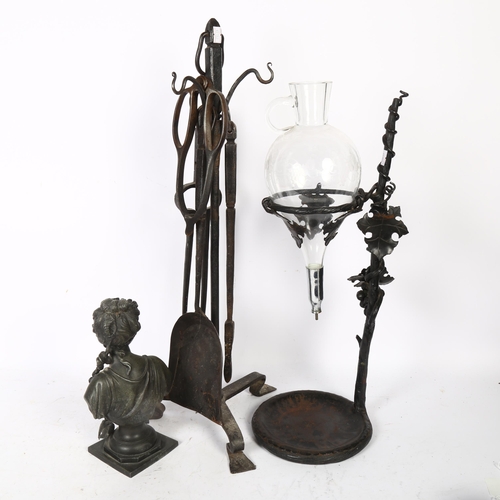 699 - A wrought-iron fire companion set on stand, a patinated spelter bust, and a wine jug on stand