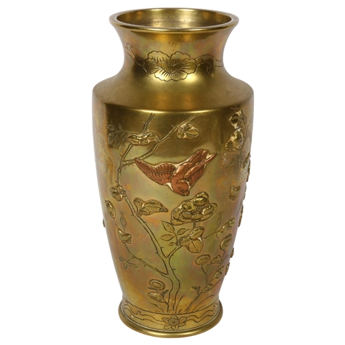 702 - A Japanese polished brass vase with embossed floral and bird decoration, 30.5cm