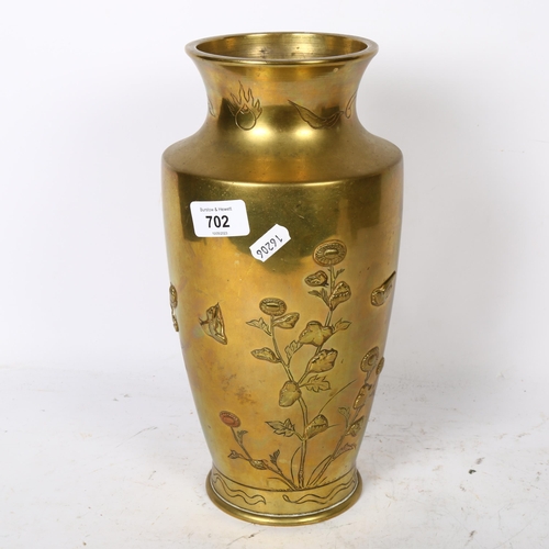 702 - A Japanese polished brass vase with embossed floral and bird decoration, 30.5cm