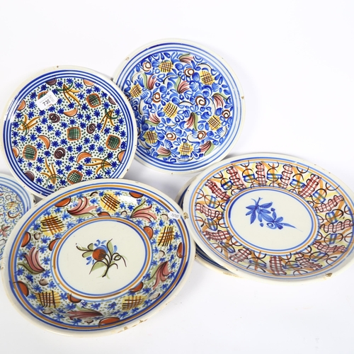 739 - A set of 4 tin glazed earthenware plates with painted decoration, 26.5cm, and 2 larger shallow dishe... 