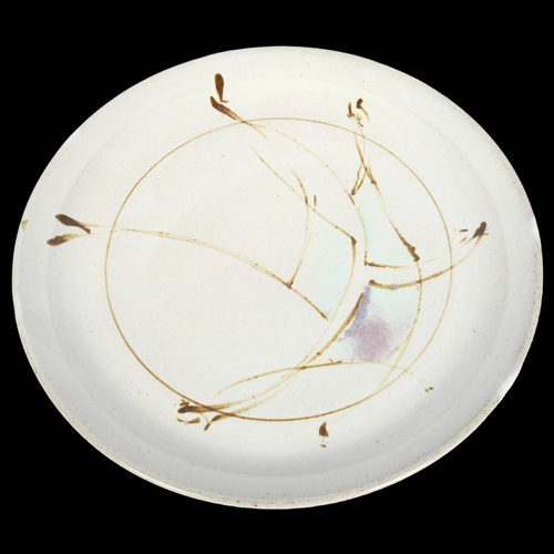 747 - A studio pottery plate with abstract design, signed to base, diameter 28cm