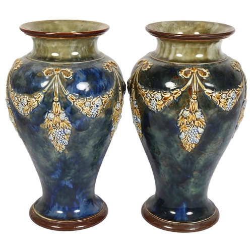 760 - A pair of Royal Doulton stoneware vases, with embossed and painted swag decoration, height 27cm and ... 