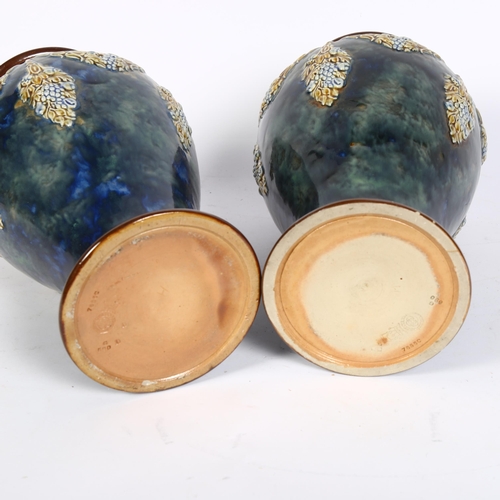 760 - A pair of Royal Doulton stoneware vases, with embossed and painted swag decoration, height 27cm and ... 